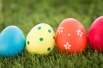 Image showing row of colored easter eggs on artificial grass