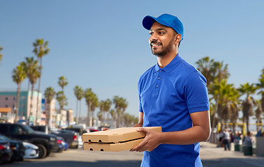 Image showing happy indian delivery man with pizza boxes in blue
