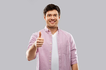 Image showing happy young man showing thumbs up