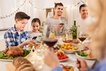 Image showing children with smartphone at family dinner party