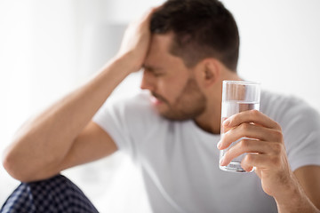 Image showing close up of sick man with glass of water