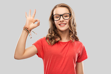 Image showing smiling student girl in glasses showing ok sign