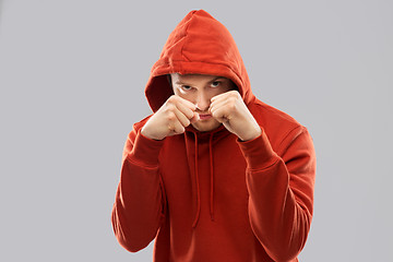 Image showing man in red hoodie fighting with fists or boxing