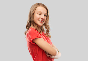 Image showing smiling teenage girl in red t-shirt over grey