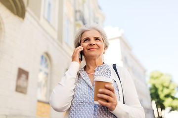 Image showing senior woman calling on smartphone in city