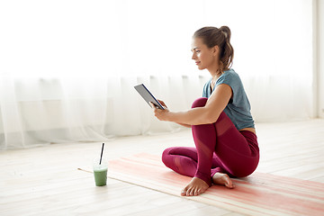 Image showing woman with tablet pc and drink at yoga studio