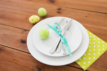 Image showing easter egg in cup holder, plates and cutlery