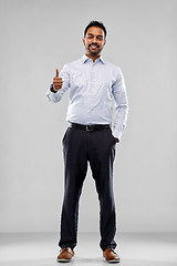 Image showing smiling indian businessman showing thumbs up