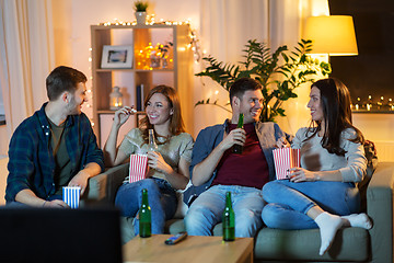 Image showing friends with beer and popcorn watching tv at home