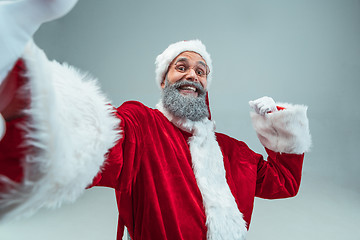 Image showing Funny guy in christmas hat. New Year Holiday. Christmas, x-mas, winter, gifts concept.