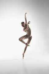 Image showing Ballerina. Young graceful female ballet dancer dancing at studio. Beauty of classic ballet.