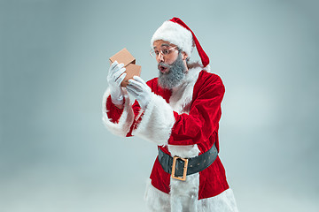 Image showing Funny guy in christmas hat. New Year Holiday. Christmas, x-mas, winter, gifts concept.