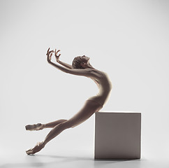 Image showing Ballerina. Young graceful female ballet dancer dancing at studio. Beauty of classic ballet.