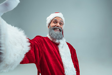 Image showing Funny guy in christmas hat. New Year Holiday. Christmas, x-mas, winter, gifts concept.