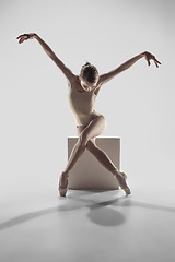 Image showing Ballerina. Young graceful female ballet dancer dancing at studio. Beauty of classic ballet.