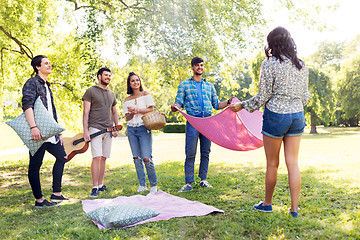 Image showing friends arranging place for picnic at summer park