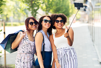 Image showing women with shopping bags taking selfie outdoors