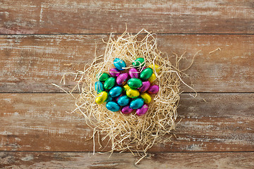 Image showing chocolate eggs in foil wrappers in straw nest