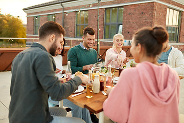 Image showing friends having dinner or rooftop party in summer