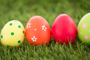 Image showing row of colored easter eggs on artificial grass