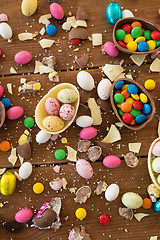 Image showing chocolate eggs and candy drops on wooden table