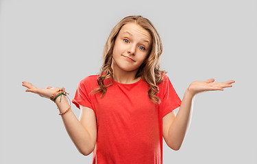 Image showing wondering teenage girl in red t-shirt shrugging