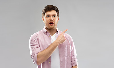 Image showing shocked young man showing something