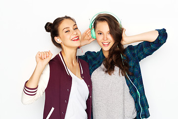 Image showing teenage girls in earphones listening to music