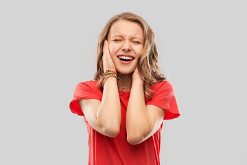 Image showing annoyed teenage girl covering her ears with hands