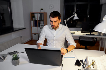 Image showing businessman with laptop working at night office