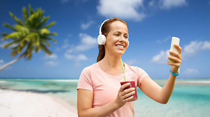 Image showing woman with smartphone and shake listening to music