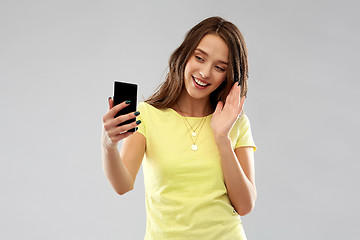 Image showing smiling teenage girl having video call smartphone