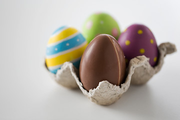 Image showing close up of chocolate and colored easter eggs