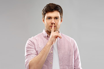 Image showing young man with finger on lips