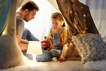 Image showing happy family playing with toy in kids tent at home