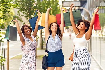 Image showing happy women with shopping bags on city street