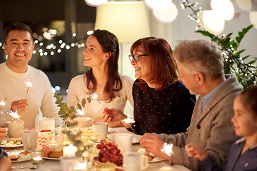 Image showing family with sparklers having tea party at home