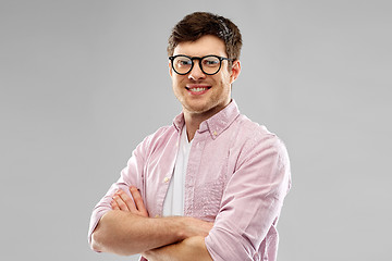 Image showing smiling young man in glasses over grey background