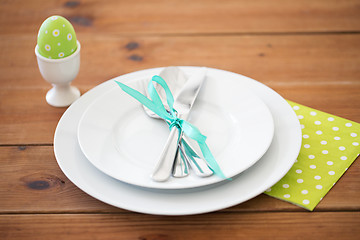 Image showing easter egg in cup holder, plates and cutlery