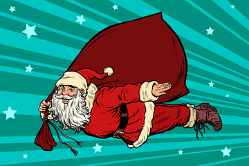 Image showing Santa Claus superhero is flying with a bag of gifts