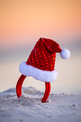 Image showing Sparkly red santa hat in the beach sand in Australia. Christmas