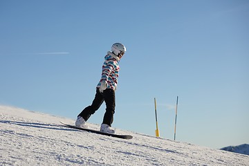 Image showing Female snowboarder in the Alps