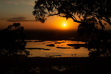 Image showing Sunrise lake views through the treetops