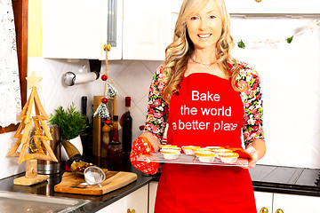 Image showing A woman with baked pastry pies in the kitchen at Christmas time