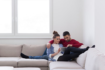 Image showing couple relaxing at  home with tablet computers