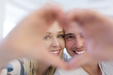 Image showing couple making heart with hands