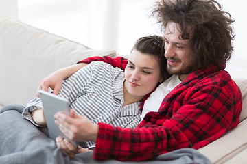 Image showing couple relaxing at  home with tablet computers