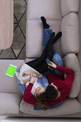 Image showing Young couple on the sofa watching television top view