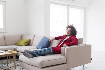 Image showing young man in bathrobe enjoying free time