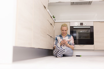 Image showing young women using mobile phone at home